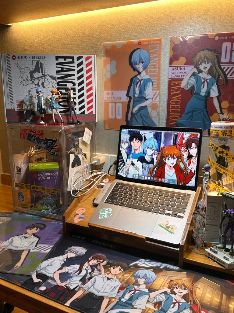 Top 10 Waifu Gifts for Your Gamer Boyfriend (That He’ll Secretly Love) | Otazoo 2 Evangelion anime desk setup with waifu mousepads and figures