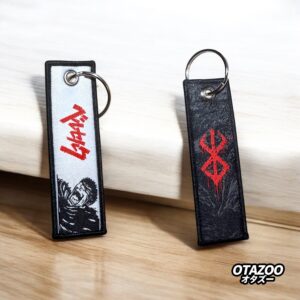 Black and red berserk key tag with double-sided embroidery featuring Guts and Brand of Sacrifice symbol