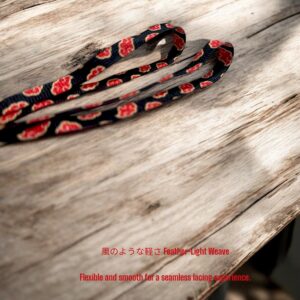 Anime shoelaces with red cloud embroidery resting on rustic wood background