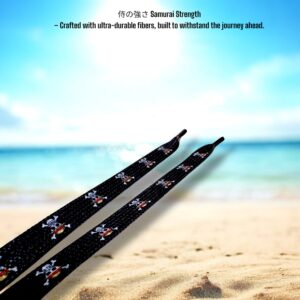Close-up of One Piece shoelace tips with Jolly Roger logo on a beach background