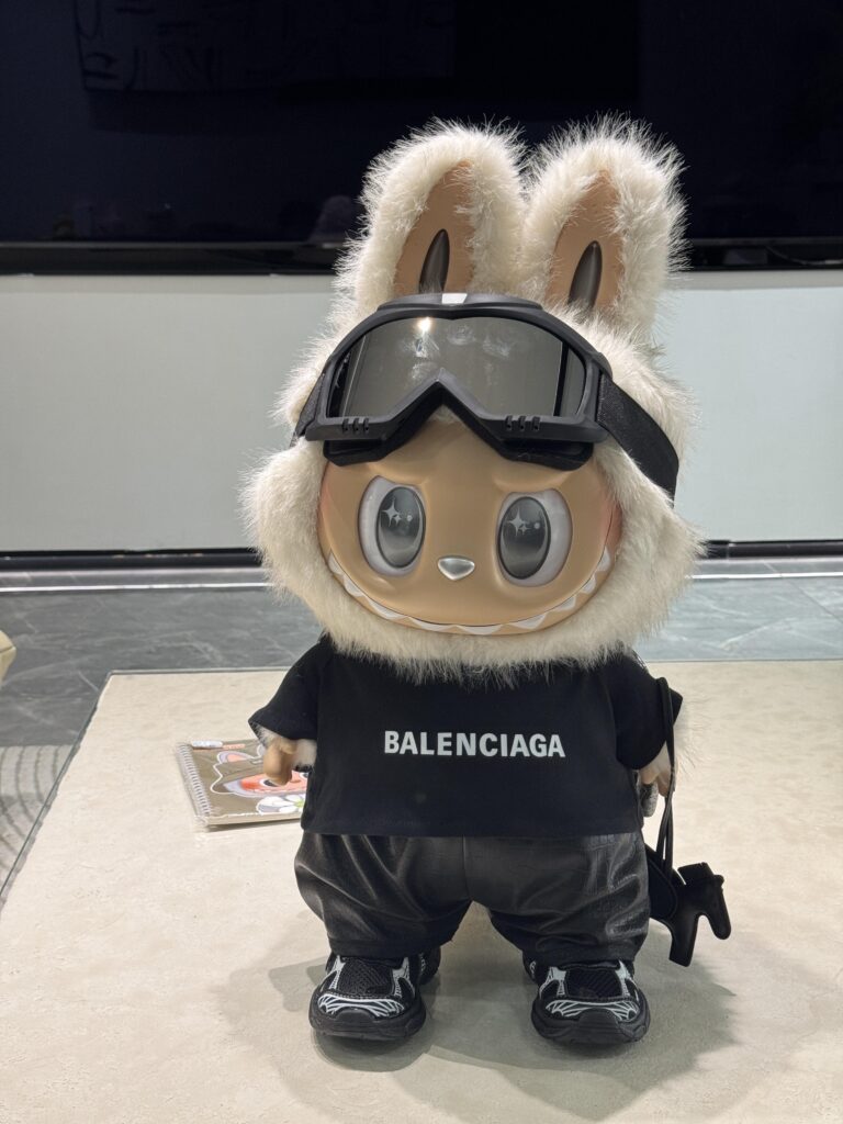 The Ultimate Labubu Collectors’ Guide (2025): Series Breakdown, Secrets, and Custom Trends 2 Custom Labubu figure dressed in Balenciaga-inspired black outfit with fur hood and goggles