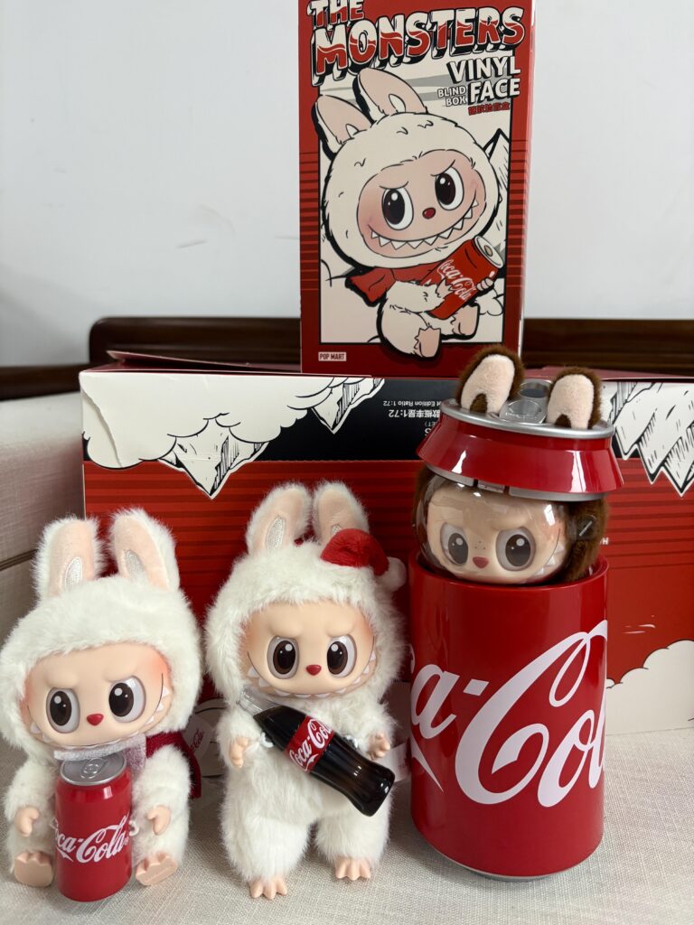The Ultimate Labubu Collectors’ Guide (2025): Series Breakdown, Secrets, and Custom Trends 1 White fur Labubu Coca-Cola collaboration figures with plush bunny outfits and limited edition soda-themed packaging