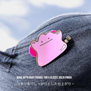 Ditto anime pin with rubber clutch resting on jeans