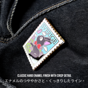 Jiji enamel pin on soft blue hat styled as vintage anime badge