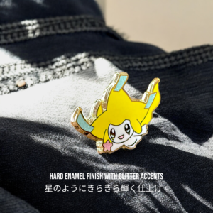 Close-up of Jirachi glitter enamel pin showing tanzaku streamers