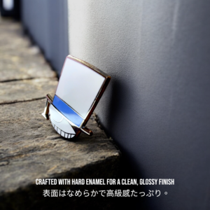 Kaitou Kid hard enamel pin standing upright on a wooden surface