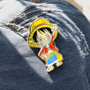 Yellow red blue one piece enamel pin closeup on ripped jeans