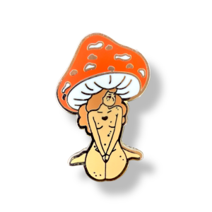Mushroom girl enamel pin with nude body under red toadstool cap on white background