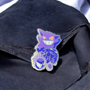 Pokemon enamel pin showing ghost-type trio with Gengar on denim fold