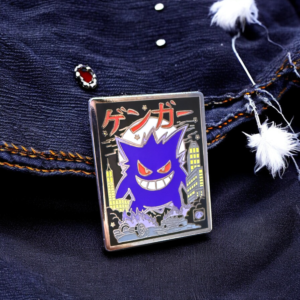 Pokemon enamel pin showing Gengar in kaiju-style setting on dark denim with patch accents