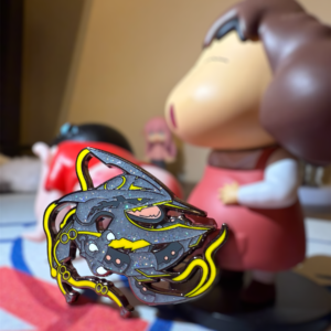 Legendary Pokémon enamel pin of Mega Rayquaza placed among anime figures on a colorful mat