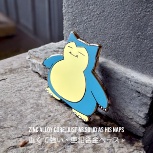 Snorlax enamel pin leaning against concrete with calm expression