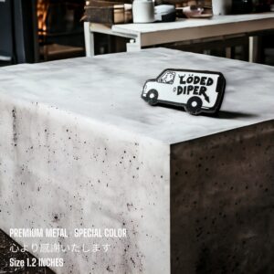 Diary of a Wimpy Kid enamel pin showing Löded Diper van on concrete desk background