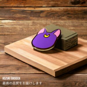 Sailor Moon enamel pin showing light purple Luna back view with crescent moon on wooden background