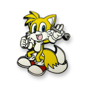 Sonic the Hedgehog enamel pin showing Tails holding wrench on white background