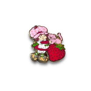 Strawberry Shortcake enamel pin showing Strawberry Shortcake hugging her cat next to a large strawberry on white background